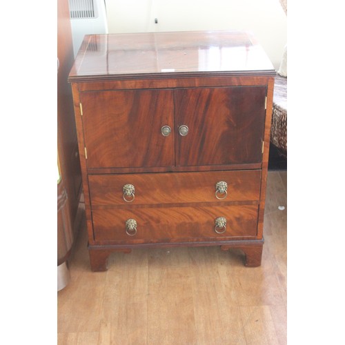 66 - A reproduction mahogany bedside linen cabinet fitted two doors above two drawers, 63cm wide.