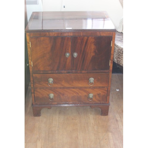 66 - A reproduction mahogany bedside linen cabinet fitted two doors above two drawers, 63cm wide.