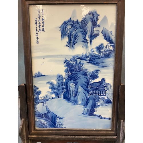 326 - A Chinese blue and white porcelain table screen, painted with a mountainous and river landscape and ... 