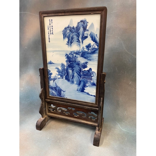 326 - A Chinese blue and white porcelain table screen, painted with a mountainous and river landscape and ... 