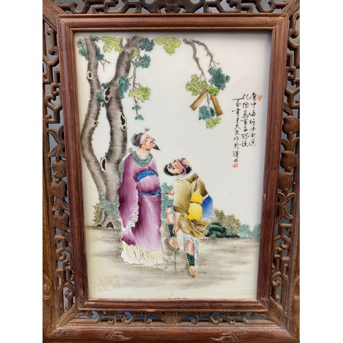 327 - A Chinese porcelain table screen, the multicoloured panel painted two figures standing beneath a tre... 