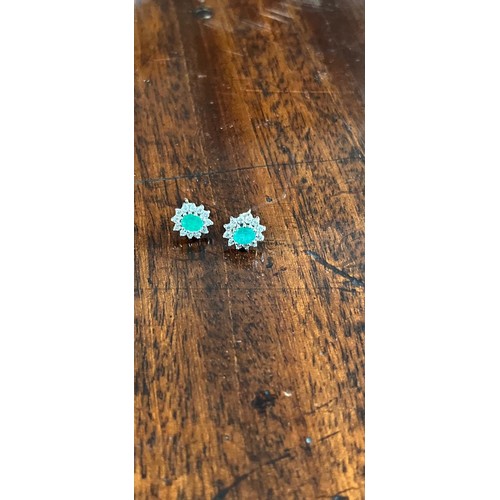 49 - A pair of diamond and emerald earrings in an H. Samuel box.