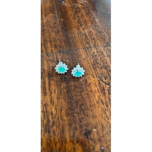 49 - A pair of diamond and emerald earrings in an H. Samuel box.