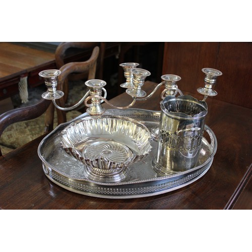 23 - An oval silver-plated two-handled gallery tray, two small candelabra, a basket with handle over, and... 