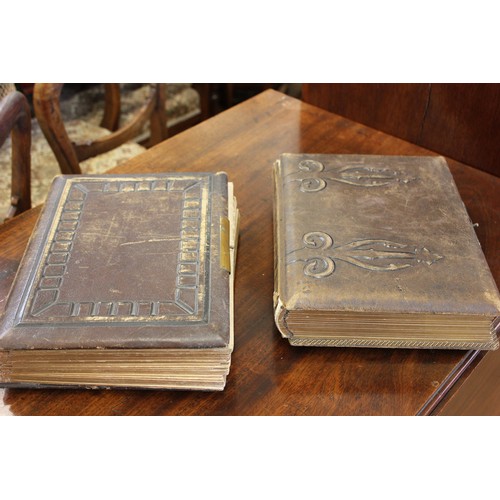 26 - Two Victorian photograph albums containing a number of family pictures, a.f. to spines and covers. (... 