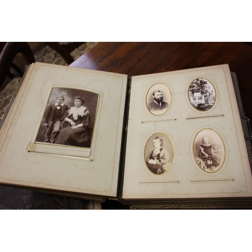 26 - Two Victorian photograph albums containing a number of family pictures, a.f. to spines and covers. (... 