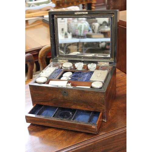 39 - An early 20th century rosewood ladies travelling toilet box, the jars & boxes with silver-plated top... 