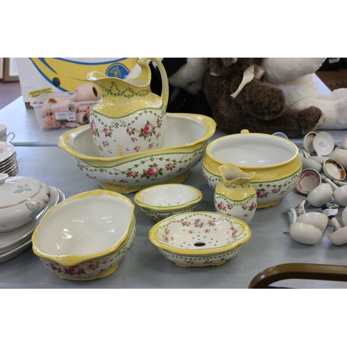 224 - A Staffordshire pottery toilet set, decorated roses within yellow bands, by 