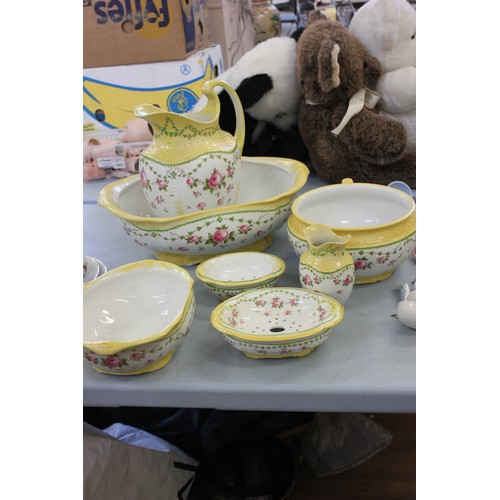 224 - A Staffordshire pottery toilet set, decorated roses within yellow bands, by 