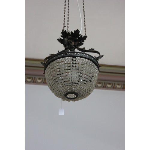 13 - A decorative metal and basket form chandelier, with three internal branches.