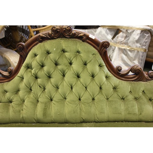 18 - A Victorian button upholstered settee.