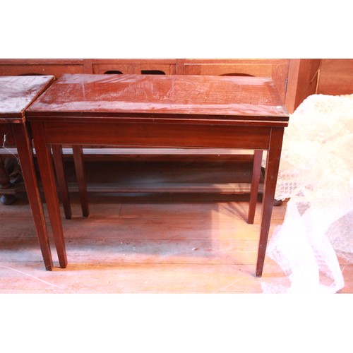 26 - A pair of 20th century mahogany card tables, on tapering legs, 91cm wide. (2)