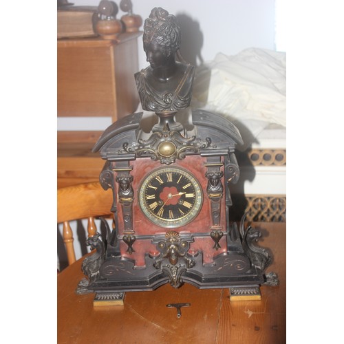 51 - A late 19th century marble French mantel clock with bronze base surrounded on the case, 60cm high.