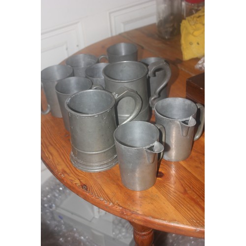 52 - Two Victorian pewter quart tankards, and a quantity of other pewter mugs (10).