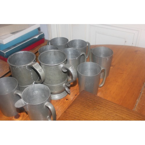 52 - Two Victorian pewter quart tankards, and a quantity of other pewter mugs (10).