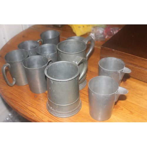 52 - Two Victorian pewter quart tankards, and a quantity of other pewter mugs (10).