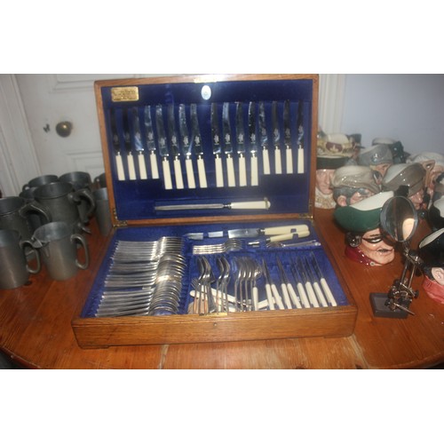 53 - A suite of silver-plated and bone-handled table cutlery in oak canteen, approx. 75 pieces.