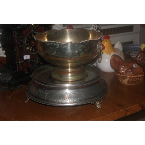 61 - A silver-plated and mirrored cakestand, 39cm in diameter, and a large silver-plated punch bowl (2).