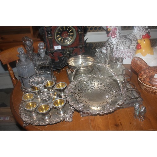 62 - A silver-plated bread basket, an egg cup set, a tray, a cruet set, a bottle stand, a rectangular tra... 