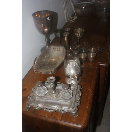 62 - A silver-plated bread basket, an egg cup set, a tray, a cruet set, a bottle stand, a rectangular tra... 