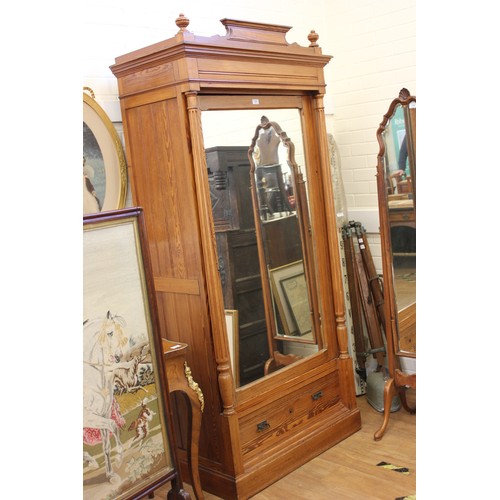 255 - A 19th century French pine armoire with mirrored panel door, flanked by fluted column pilasters, 95c... 