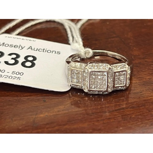 238 - An 18ct white-gold dress ring, set approx. 60 diamonds, in groups.