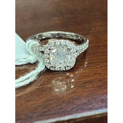 241 - A 14k white-gold dress ring, set a central diamond, approx. 1.25 carats, and a number of tiny diamon... 