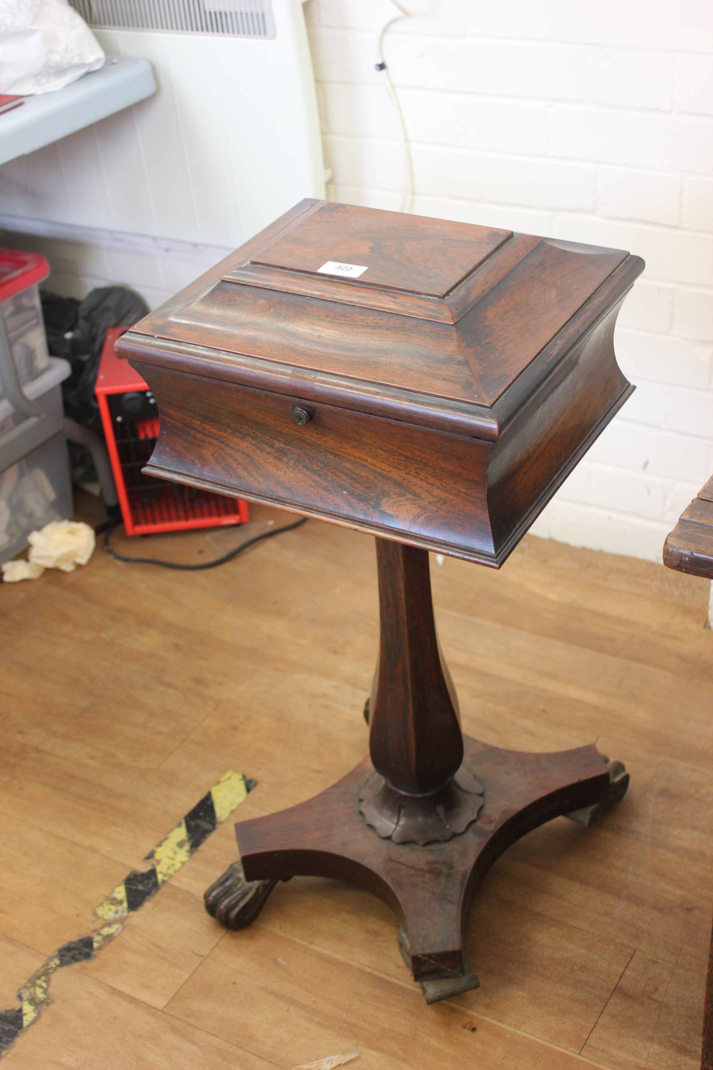 An early Victorian rosewood teapoy, on faceted vase column and ...