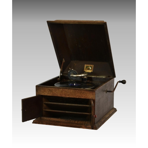 214 - An oak cased ' His Masters Voice ' model 103 table-top gramophone, the hinged front doors opening to... 
