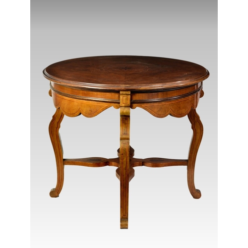 553 - An Edwardian inlaid walnut circular centre table, the moulded top quarter veneered with broad cross ... 