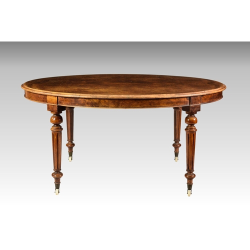 554 - A Victorian burr walnut oval dining table, the moulded quarter veneered top over a figured walnut fr... 
