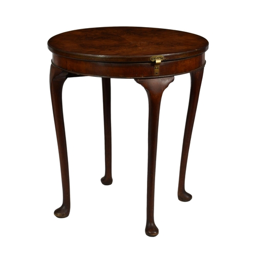 352 - A 1930s quarter veneered figured walnut circular card table, the top hinged and swivelling to reveal... 