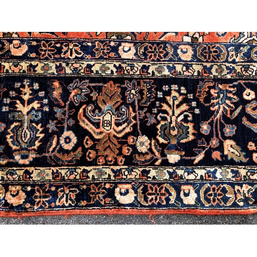 288 - An antique Persian carpet, probably 19th or early 20th century, with all over floral, vase and folia... 