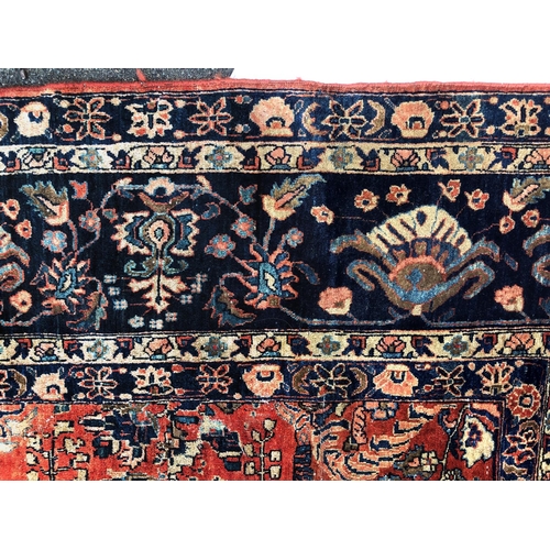 288 - An antique Persian carpet, probably 19th or early 20th century, with all over floral, vase and folia... 