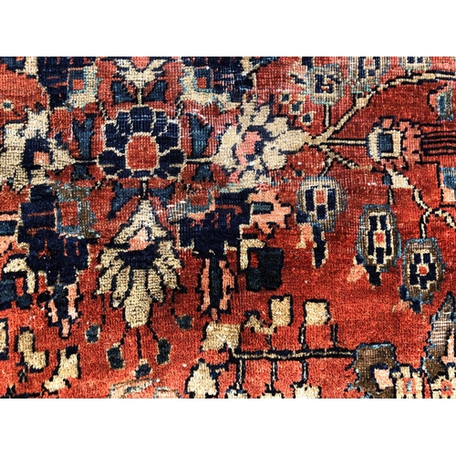 288 - An antique Persian carpet, probably 19th or early 20th century, with all over floral, vase and folia... 