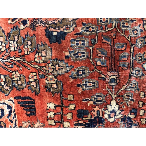 288 - An antique Persian carpet, probably 19th or early 20th century, with all over floral, vase and folia... 