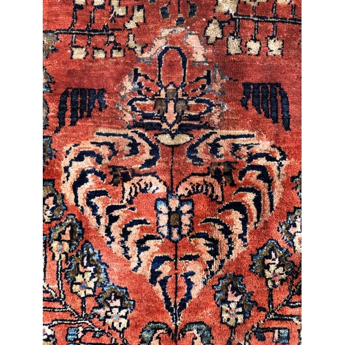288 - An antique Persian carpet, probably 19th or early 20th century, with all over floral, vase and folia... 