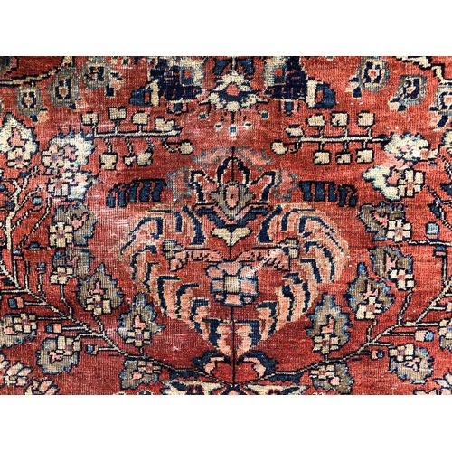 288 - An antique Persian carpet, probably 19th or early 20th century, with all over floral, vase and folia... 