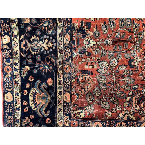 288 - An antique Persian carpet, probably 19th or early 20th century, with all over floral, vase and folia... 