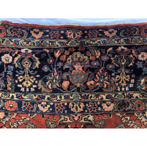 288 - An antique Persian carpet, probably 19th or early 20th century, with all over floral, vase and folia... 