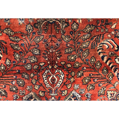 288 - An antique Persian carpet, probably 19th or early 20th century, with all over floral, vase and folia... 