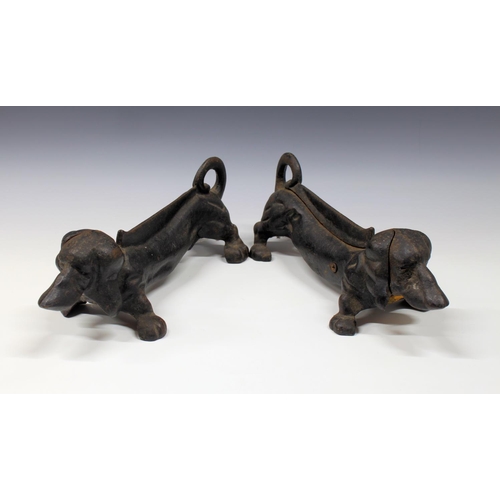 115 - A pair of heavy cast metal novelty boot scrappers fashioned as Dachshunds. (2)