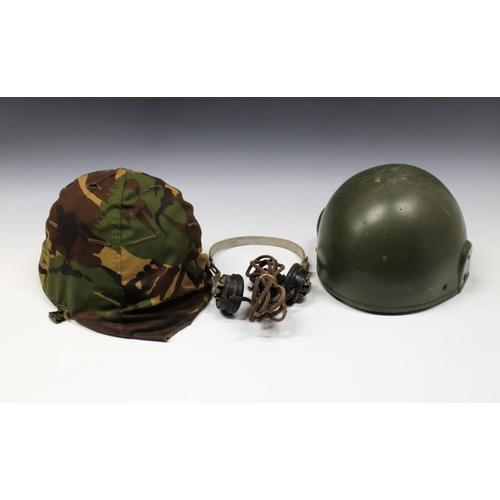 303 - Two Military helmets and a pair of earphones.,