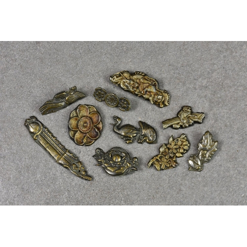 349 - A good selection of soft metal Menuki sword furniture, probably Meiji period, each piece picked out ... 