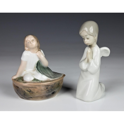 352 - A Royal Copenhagen Thumbelina 4374 figurine, depicting Thumbelina in a walnut shell, together with a... 
