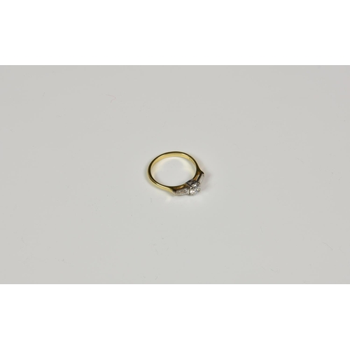 821 - An 18ct yellow gold and diamond 3 stone ring, the central brilliant cut diamond of good colour and c... 