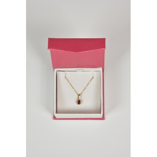 919 - A 9ct gold, ruby and diamond three stone pendant, on an 18in. 9ct gold trace chain.