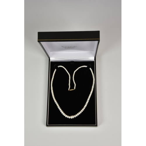 926 - A 17in. freshwater pearl necklace, with graduated pearls and 9ct gold clasp.