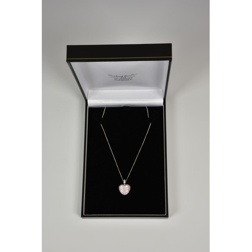 929 - A 9ct white gold and pink mother-of-pearl heart pendant, on an 18in. 9ct white gold curb link chain.