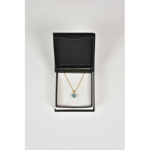 931 - A 9ct gold and blue topaz pendant, on an 18in. 9ct gold curb link chain.